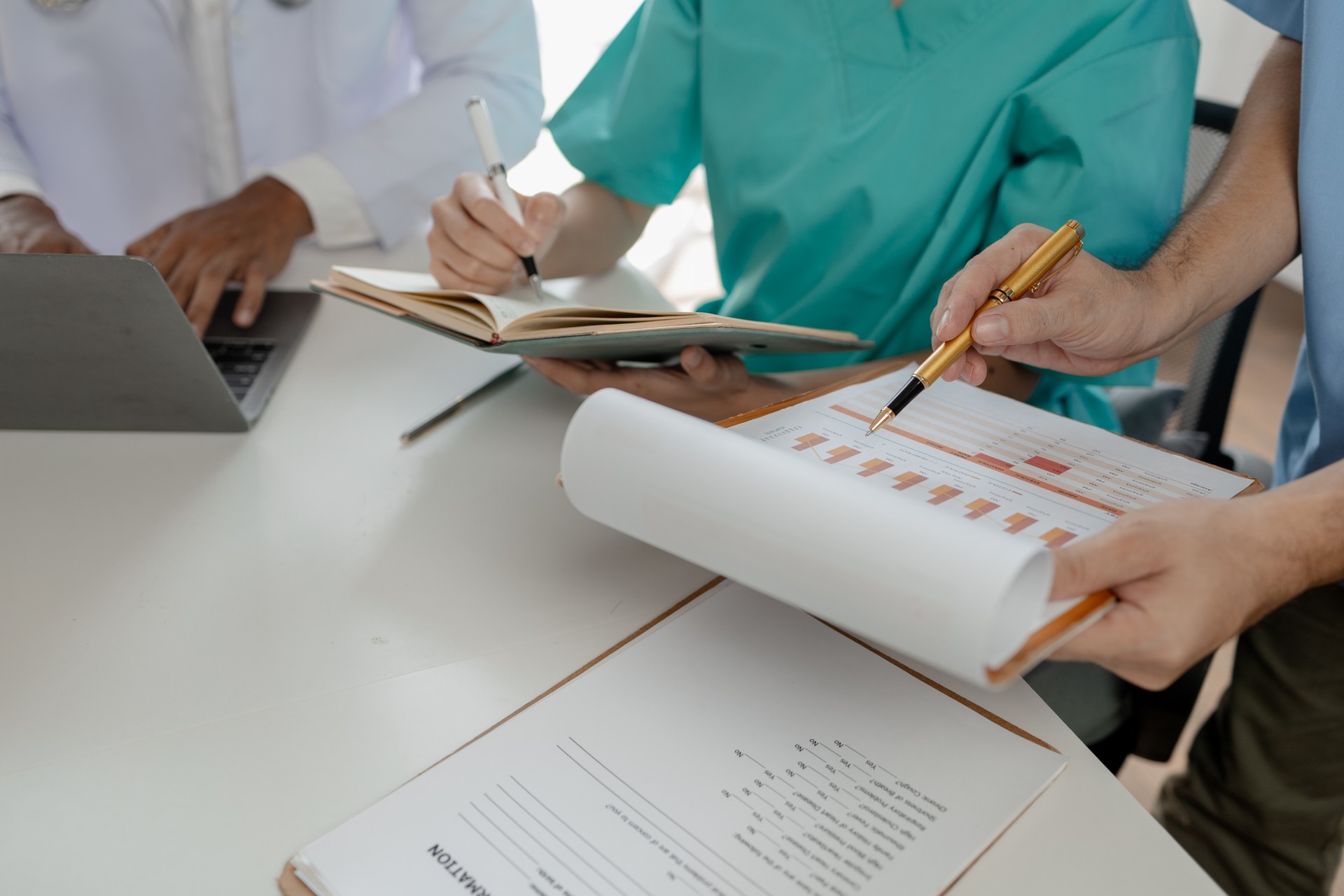 A group of doctors meets together to solve the problem of the epidemic, There was a meeting about major surgery in the hospital, The doctor takes the patient's documents and discusses them with team.